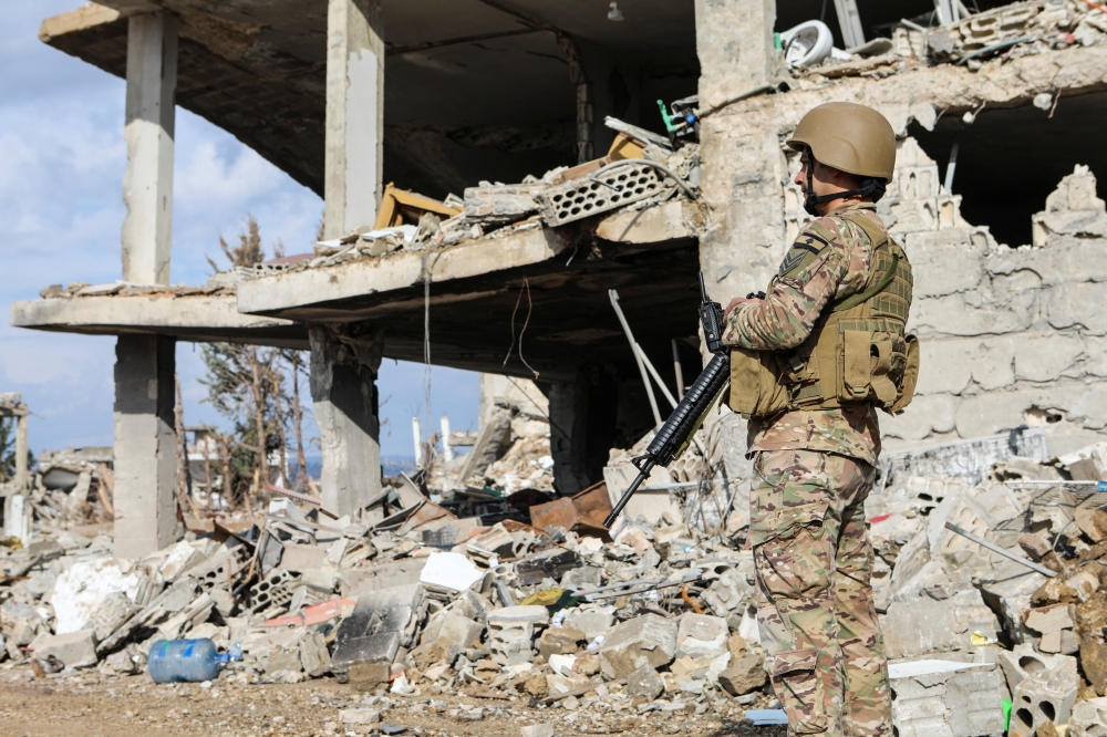 A Lebanese army member stands near rubble at a damaged site in the Lebanese village of Khiam. — Reuters 