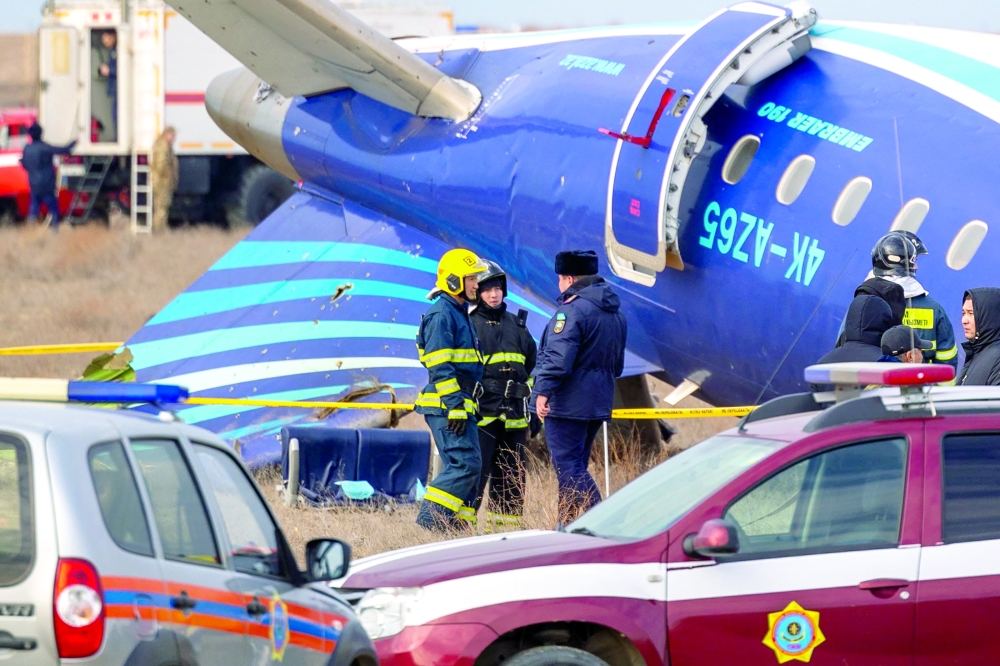 Emergency specialists work at the crash site of an Azerbaijan Airlines passenger jet near the western Kazakh city of Aktau 
