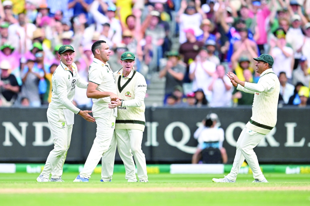 Australia's Scott Boland celebrates with team-mates after taking the wicket of India's Virat Kohli James Ross/AAP Image via REUTERS