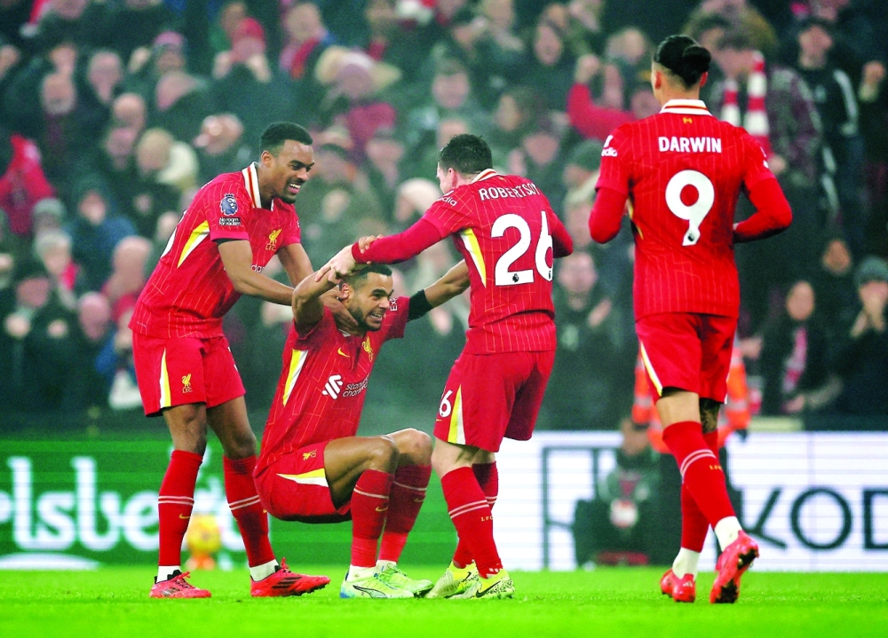 Liverpool's Cody Gakpo celebrates scoring their first goal with team-mates REUTERS