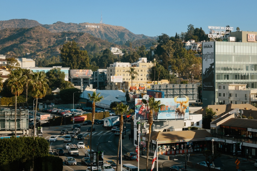 The landmark Hollywood sign on Mount Lee stands above traffic, billboards and a jumble of development in a section of Los Angeles, Dec. 20, 2024. (Stella Kalinina/The New York Times)