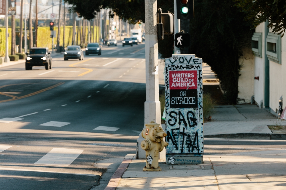 A poster and graffiti left over from the 2023 Writers Guild of America strike, in Los Angeles, Dec. 20, 2024. (Stella Kalinina/The New York Times)