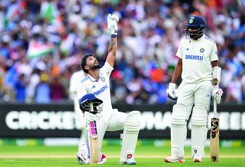 India's Nitish Kumar Reddy celebrates his century as Mohammed Siraj looks on. AAP/Reuters