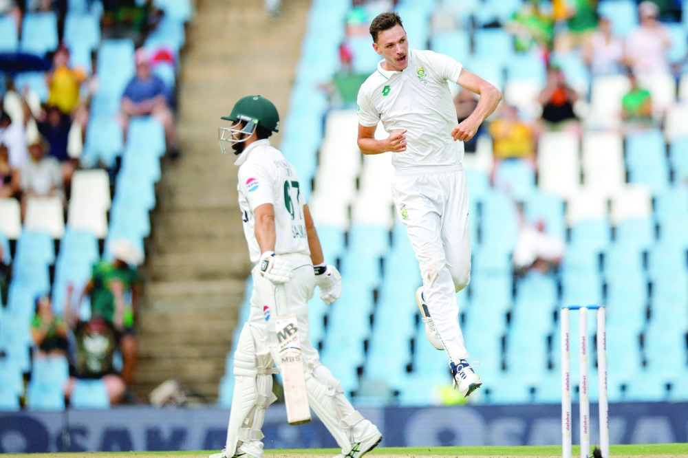 South Africa's Marco Jansen (R) celebrates after the dismissal of Pakistan's Salman Agha (L) during the third day of the first cricket Test match between South Africa and Pakistan at SuperSport Park in Centurion on December 28, 2024. (Photo by PHILL MAGAKOE / AFP)