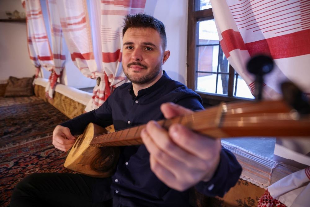 Bosnian musician Zanin Berbic plays the saz, a traditional instrument, during a performance of the traditional love song Sevdalinka, in Sarajevo, Bosnia and Herzegovina, December 20, 2024. REUTERS/Amel Emric
