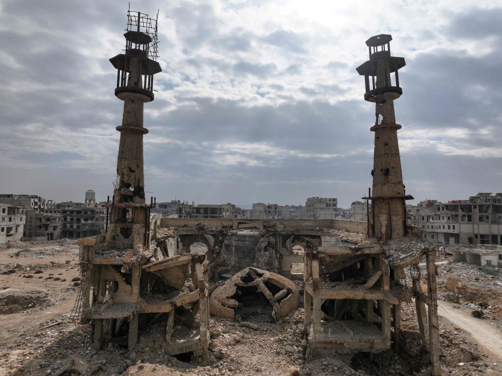 This aerial view shows a destroyed mosque in a neighbourhood devastated by the Syrian civil war in Daraya, a suburb of Damascus. — AFP