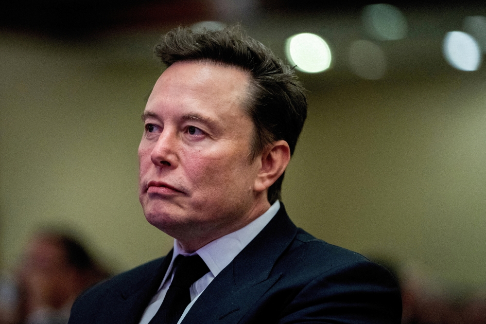 Tesla CEO and X owner Elon Musk listens as US President-elect Donald Trump speaks during a meeting, in Washington. — Reuters 