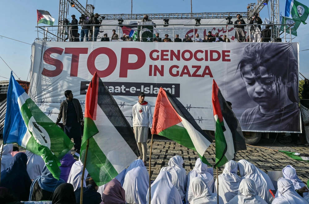 Activists of Pakistan's Jamaat-e-Islami (JI) party take part in a 'Gaza Million March' to express their solidarity with the Palestinians, in Islamabad on December 29, 2024, amid the ongoing war between Israel and militant group Hamas.