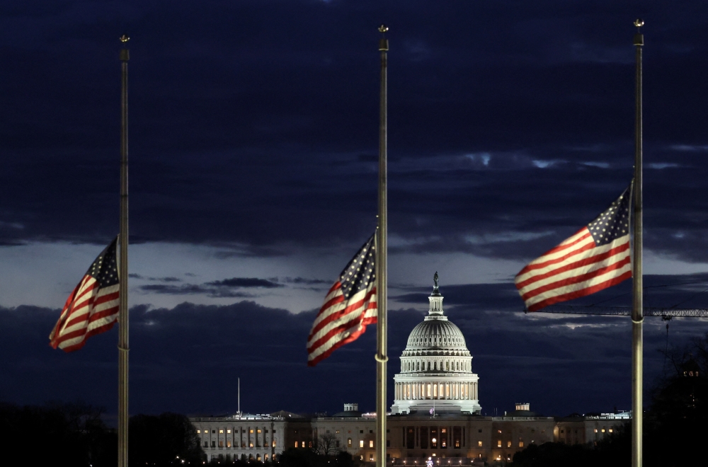 With the U.S. Capitol in the distance, flags fly at half-staff at the Washington Monument on the National Mall following the death of former U.S. President Jimmy Carter, in Washington, US. — Reuters 
