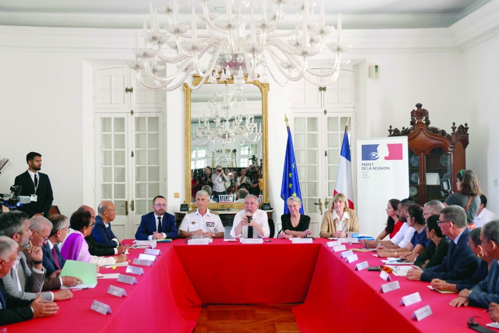 France's Prime Minister Francois Bayrou (C) and officials attend a meeting at the Prefecture of La Reunion, in a two-day visit of cyclone-hit Mayotte. — AFP