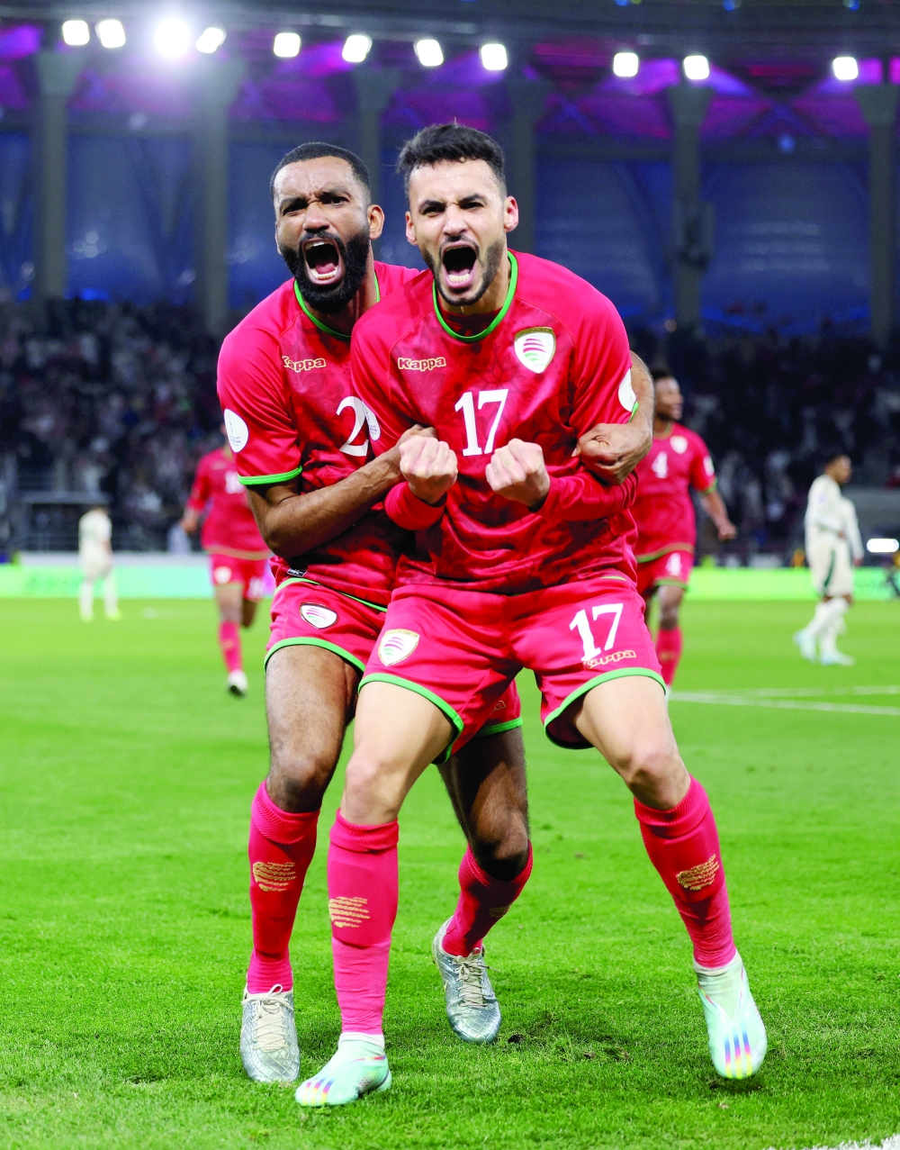 Oman's Ali al Busaidy celebrates scoring their second goal with Harib al Saadi REUTERS/Mohamed Abd El Ghany
