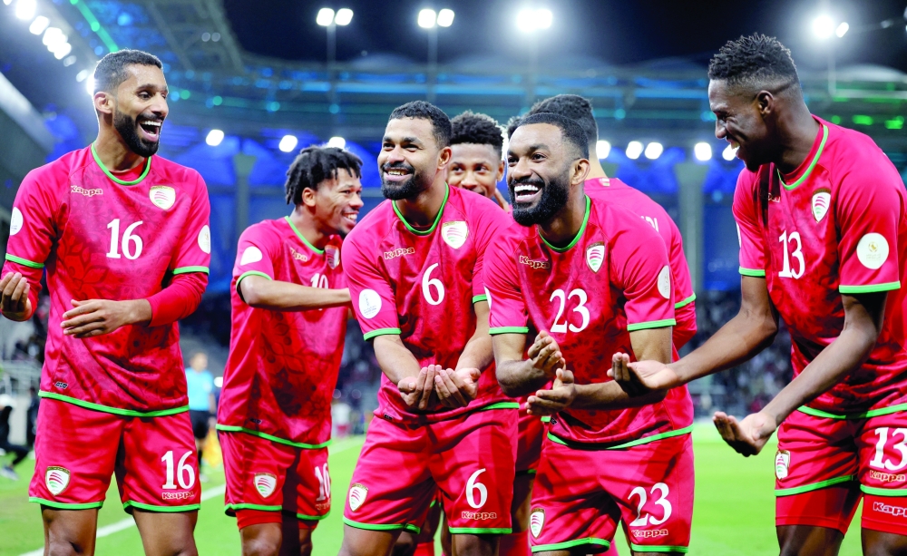 Oman's Ahmed al Khamisi and Harib al Saadi celebrate after Arshad al Alawi scored their first goal REUTERS/Mohamed Abd El Ghany