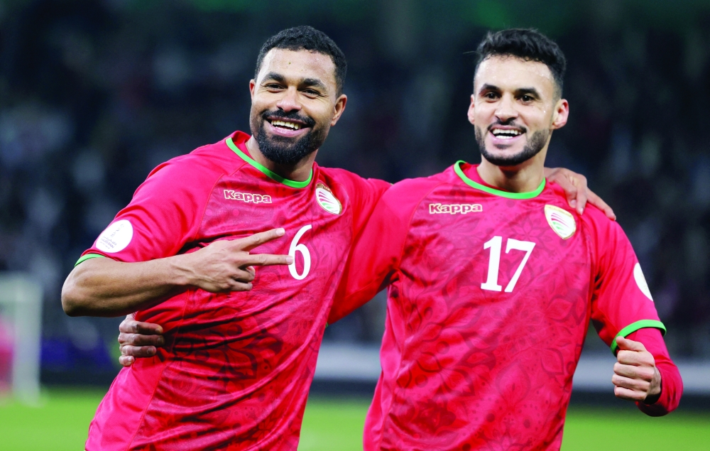 Oman's Ali al Busaidy celebrates scoring their second goal with Ahmed al Khamisi REUTERS/Mohamed Abd El Ghany
