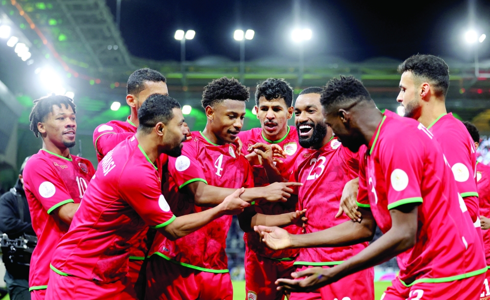 Oman's Arshad al Alawi celebrates scoring their first goal with team-mates REUTERS/Mohamed Abd El Ghany