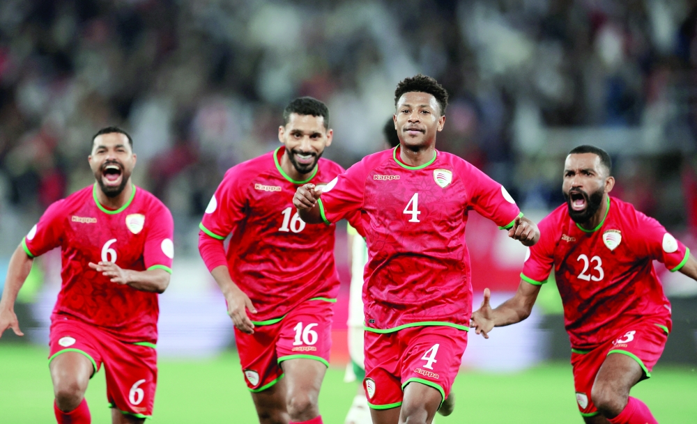 Oman's Arshad al Alawi celebrates scoring their first goal with team-mates REUTERS/Mohamed Abd El Ghany