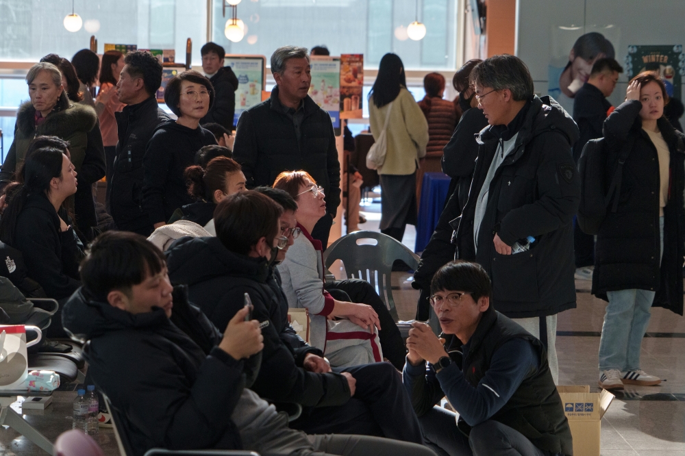 Families gather at Muan International Airport in Muan, South Korea, Tuesday, Dec. 31, 2024. (Chang W. Lee/The New York Times)