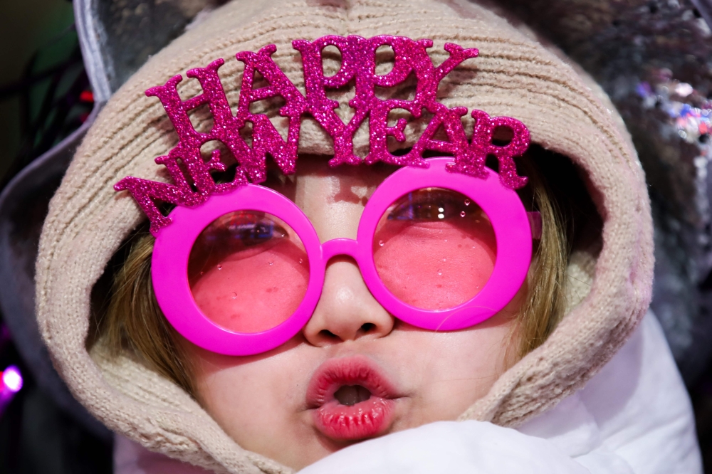 A reveler celebrates New Year's Eve in Times Square on December 31, 2024, in New York City.  (Photo by Leonardo Munoz / AFP)

