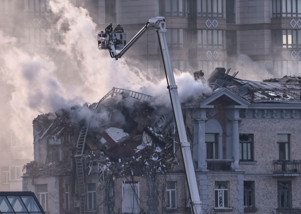 Firefighters work at a site of a building damaged during a Russian drone strike, in central Kyiv. — Reuters 