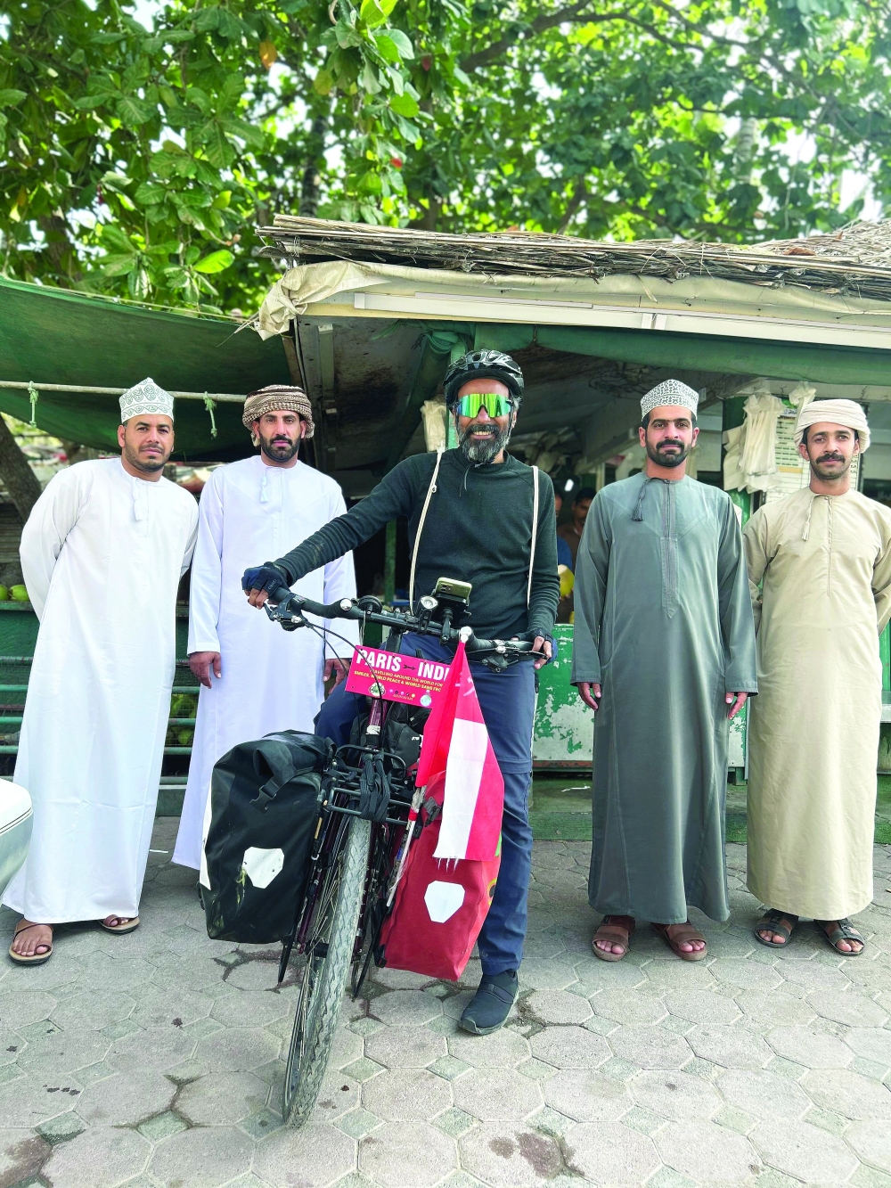 Cyclist Arun Thadagath with local citizens in Salalah