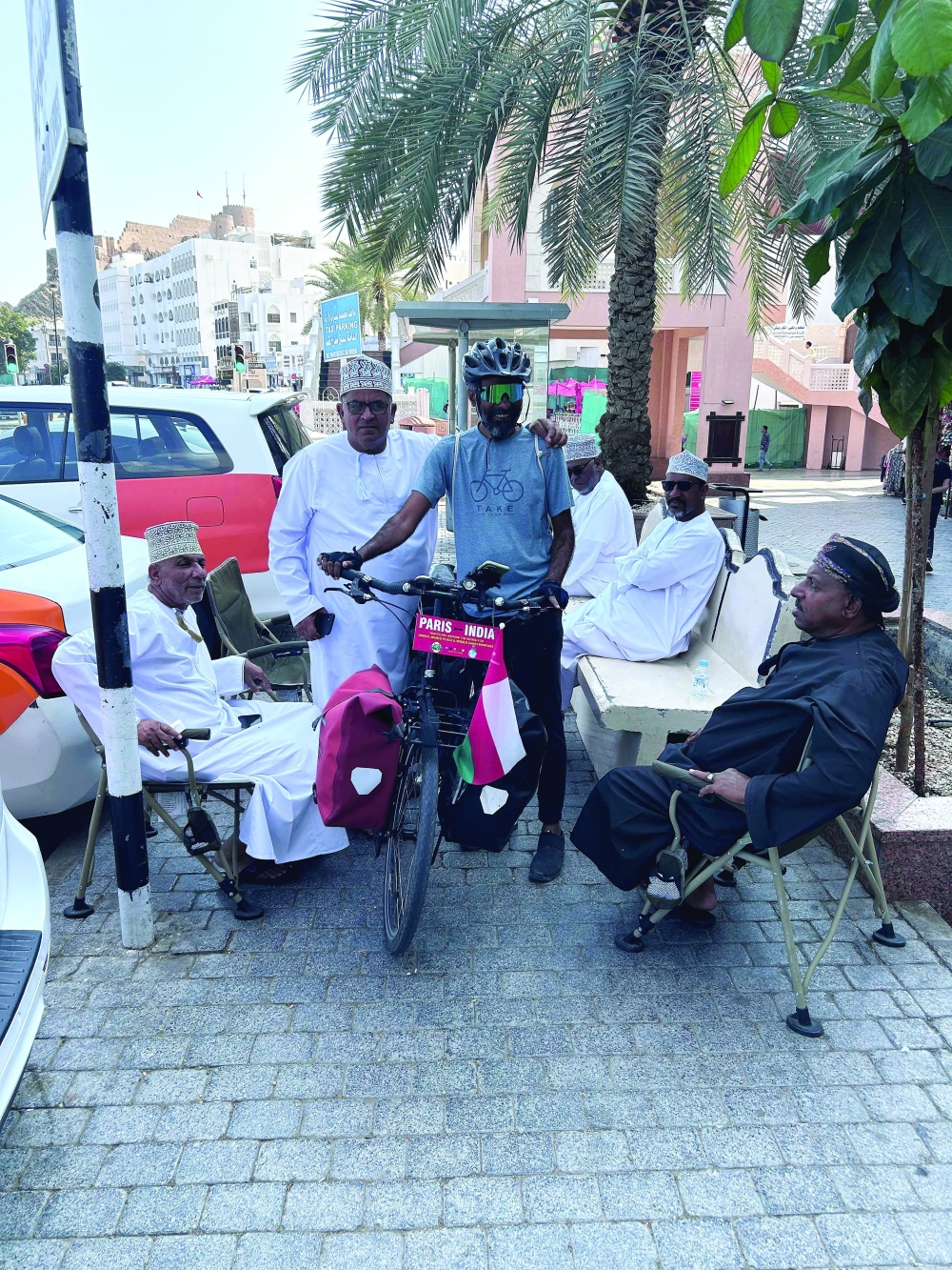 At Muttrah souq, cyclist Arun Thadagath poses with Omani taxi drivers