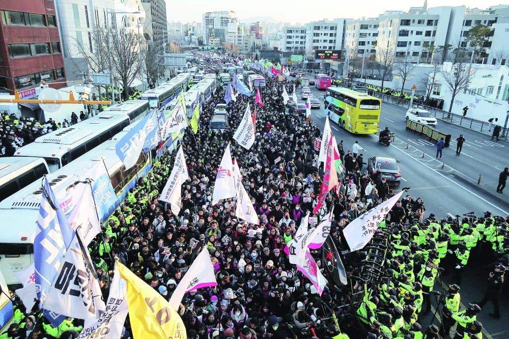 Anti-Yoon protesters clash with police officers as they march towards impeached South Korean President Yoon Suk Yeol's official residence, in Seoul. — Reuters