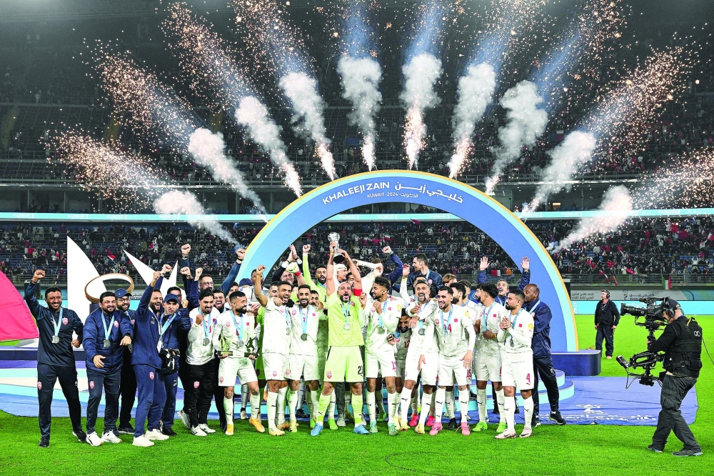 Bahrain's players celebrate on the podium after winning the 26th Arabian Gulf Cup final football match between Oman and Bahrain at Jaber al-Ahmad al-Sabah Stadium In Kuwait City on January 4, 2025.  (Photo by Yasser AL ZAYYAT / AFP)

