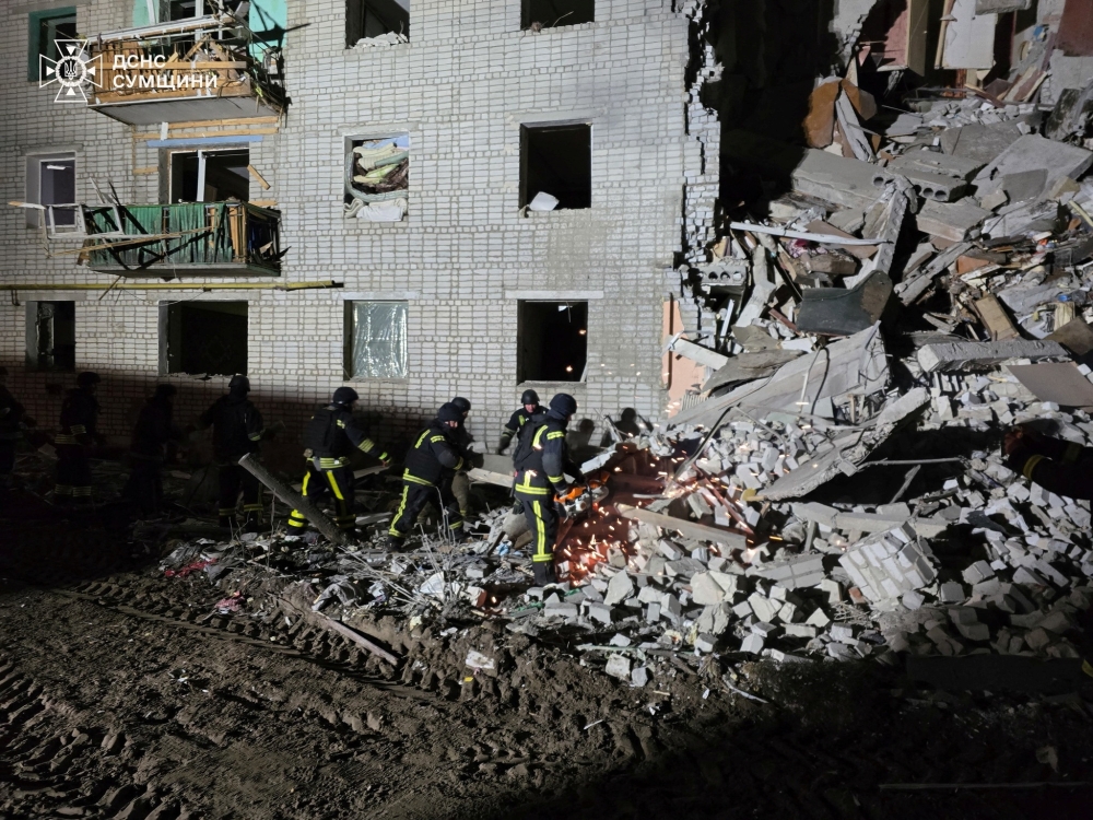 Rescuers work at the site of a residential building hit by a Russian air strike, in Sumy region, Ukraine. — Reuters 