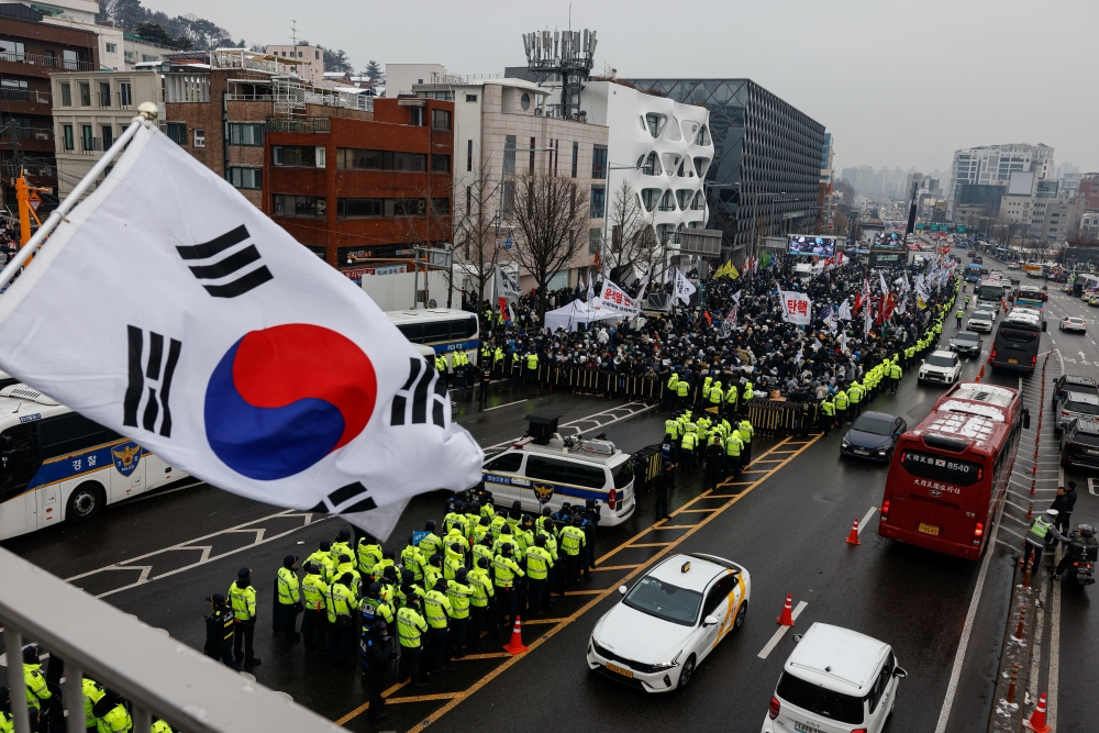 Police stand guard, blocking the road leading to the official residence of impeached South Korean President Yoon Suk Yeol as protesters gather, in Seoul. — Reuters 