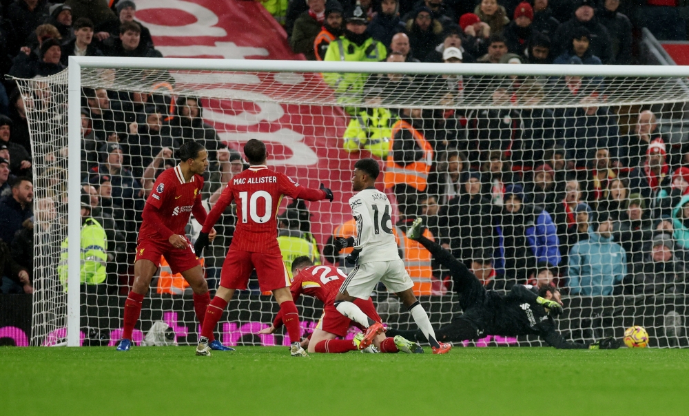 Manchester United's Amad Diallo scores their second goal past Liverpool's Alisson Becker — Reuters.