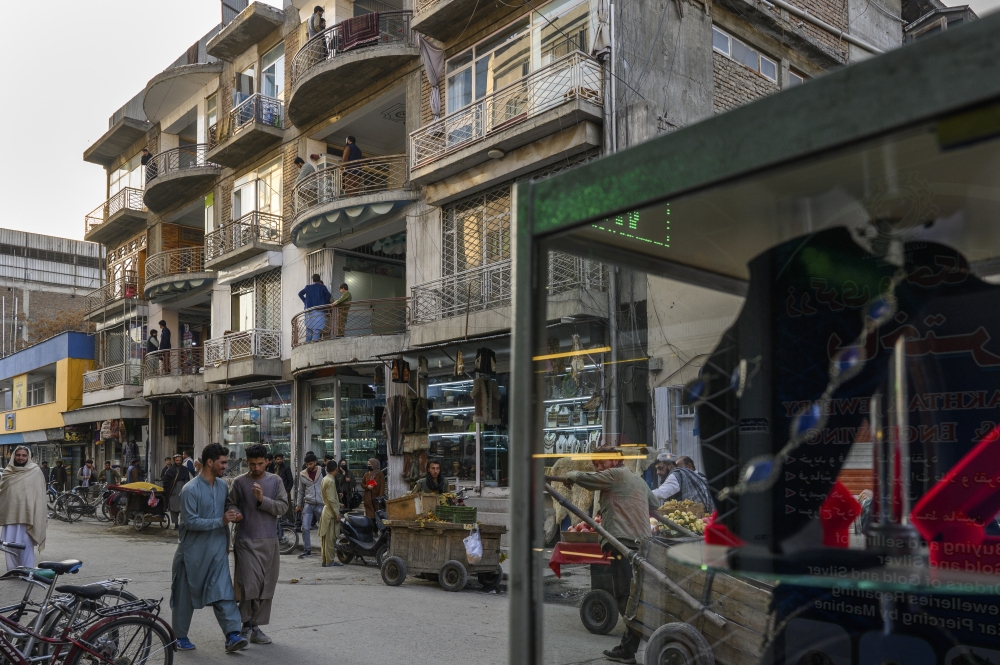 An old four-story installation that serves as a gemstone market, housing dozens of cell-like shops, on a busy commercial street in Kabul, the capital of Afghanistan, Nov. 21, 2024. (Elise Blanchard/The New York Times)