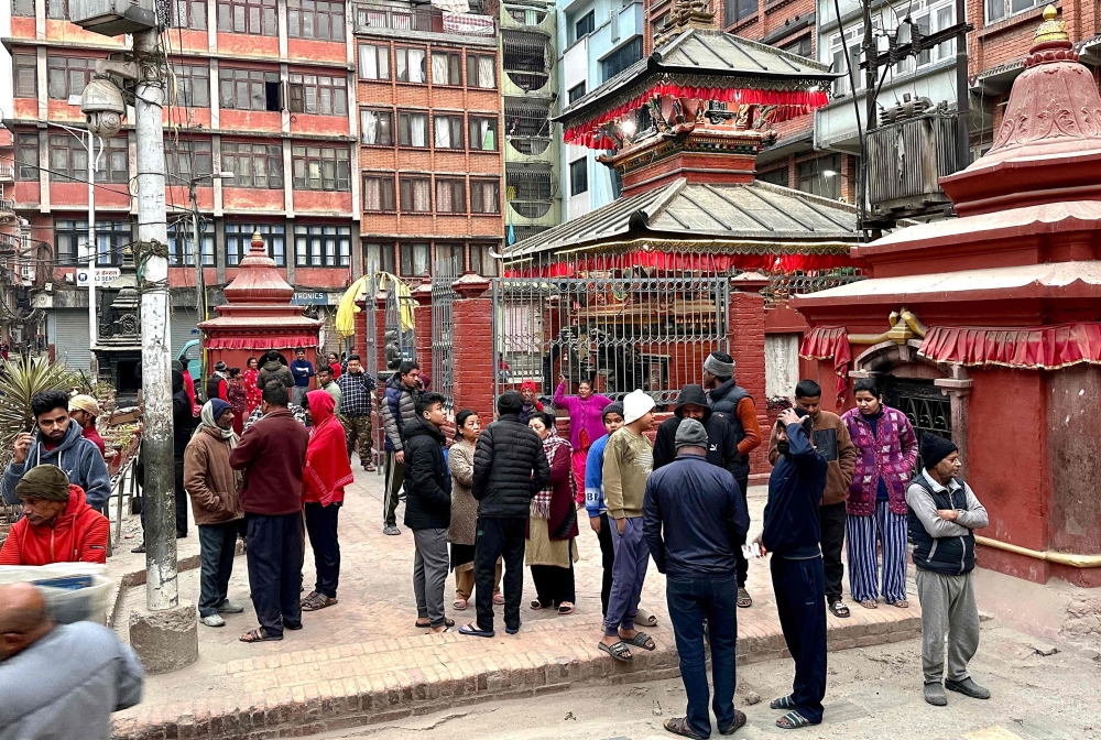 People gather in an open area following earthquake tremors in Kathmandu. — AFP 