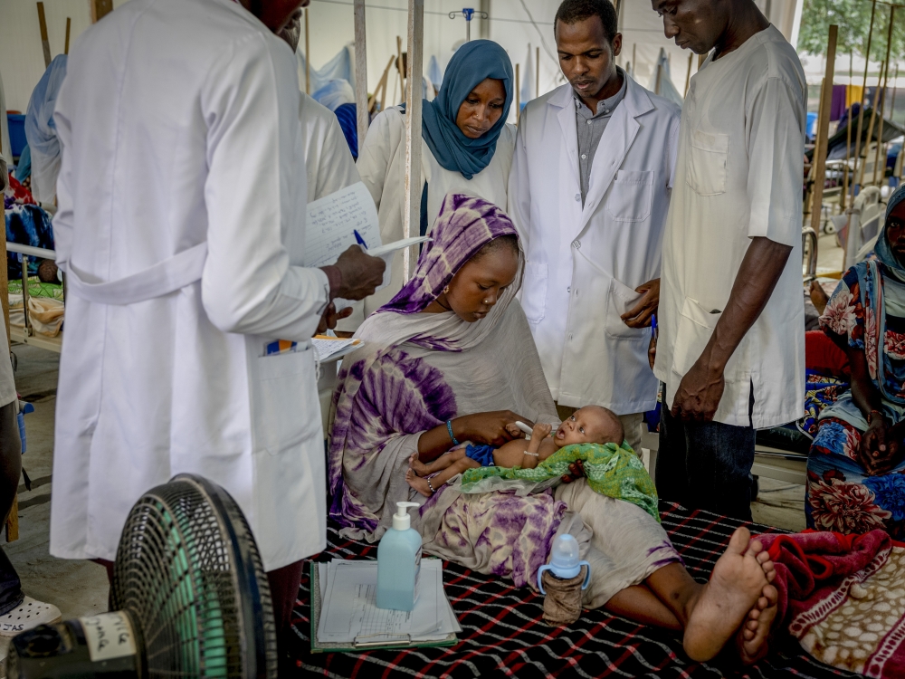 Fatuma Adoum, a refugee from Sudan, with one of her infant twin daughters at a malnutrition center run by Doctors Without Borders in Adre, Chad, July 11, 2024. (Ivor Prickett/The New York Times)