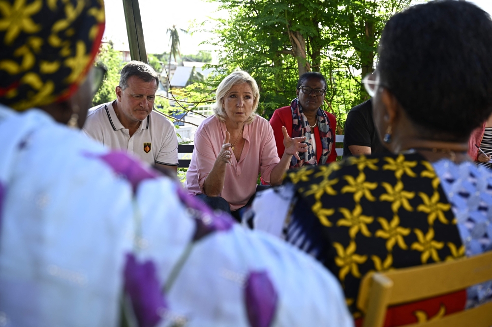 President of French far right party Rassemblement National parliamentary group Marine Le Pen during a meeting with representatives of local citizen associations ahead of her departure at the end of her visit on the French Indian Ocean territory of Mayotte, weeks after a devastating cyclone hit the archipelago in Mamoudzou. - AFP
