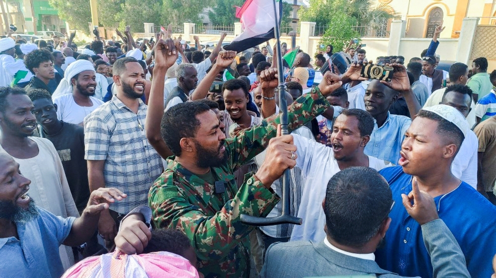 Sudanese citizens celebrate following an announcement by the army that it took over the city of Wad Madani. — Reuters 