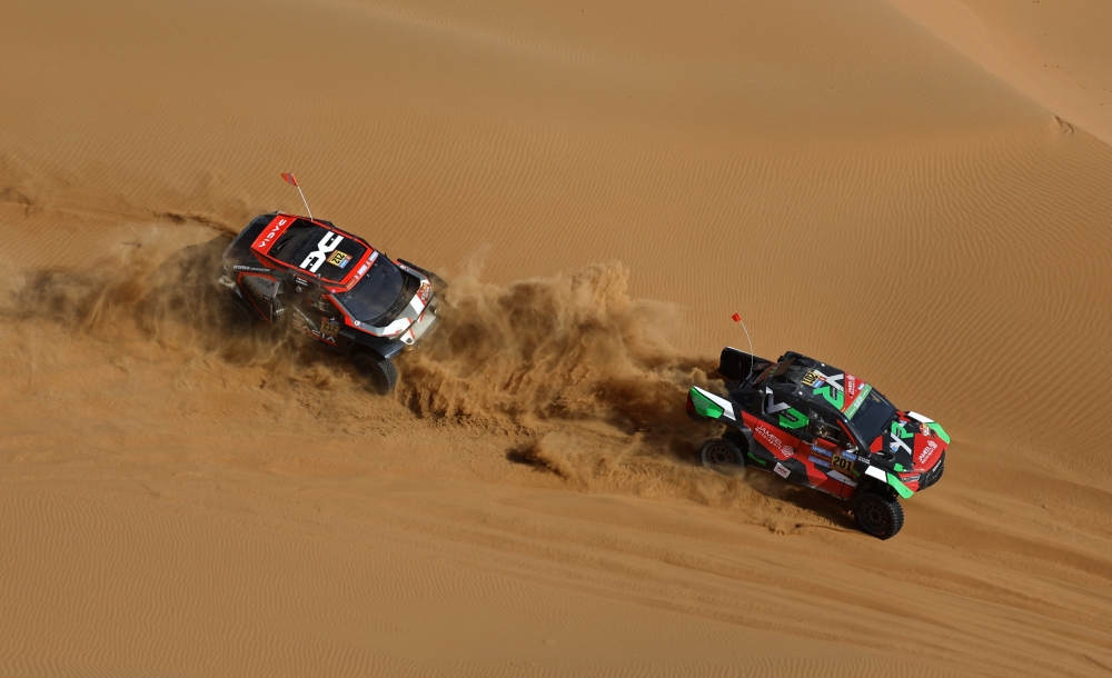 Overdrive Racing's Yazeed Al-Rajhi and Timo Gottschalk in action with The Dacia Sandriders' Cristina Gutierrez and Pablo Moreno during the Dakar Rally Stage 11 in Shubaytah, Saudi Arabia. -- Reuters