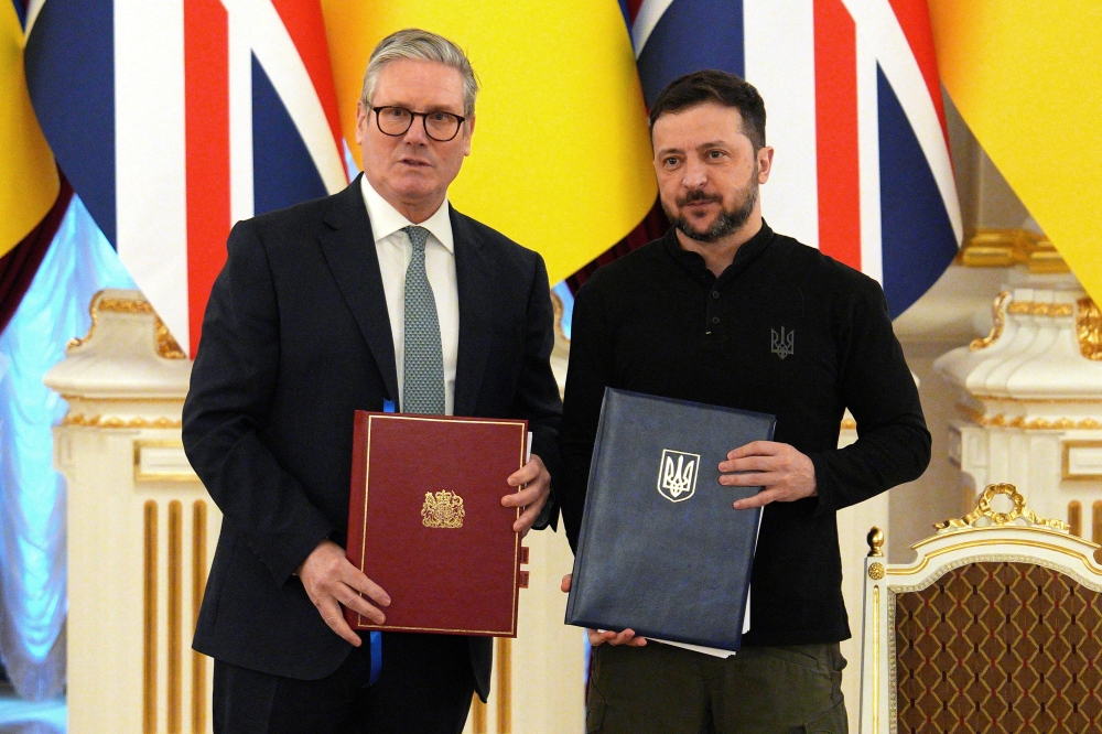British Prime Minister Keir Starmer and Ukrainian President Volodymyr Zelensky pose after holding a signing ceremony to commemorate a 100-year partnership between the countries at Mariinskyi Palace in Kyiv. - Reuters 