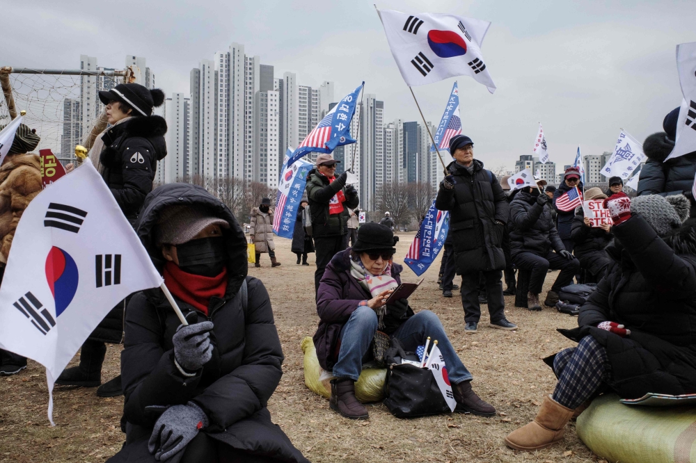 Supporter of impeached South Korean president Yoon Suk Yeol gather for a rally outside the government complex building housing the Corruption Investigation Office for High-ranking Officials in Gwacheon. - AFP