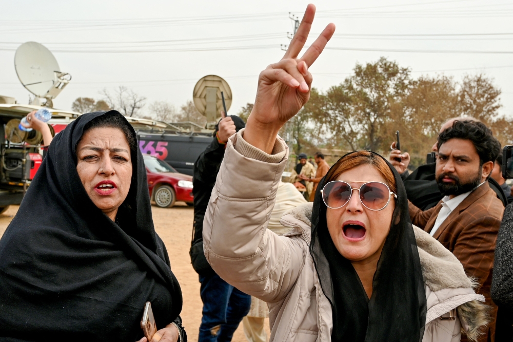 Pakistan's imprisoned former prime minister Imran Khan's supporters shout slogans outside the Adiala prison in Rawalpindi