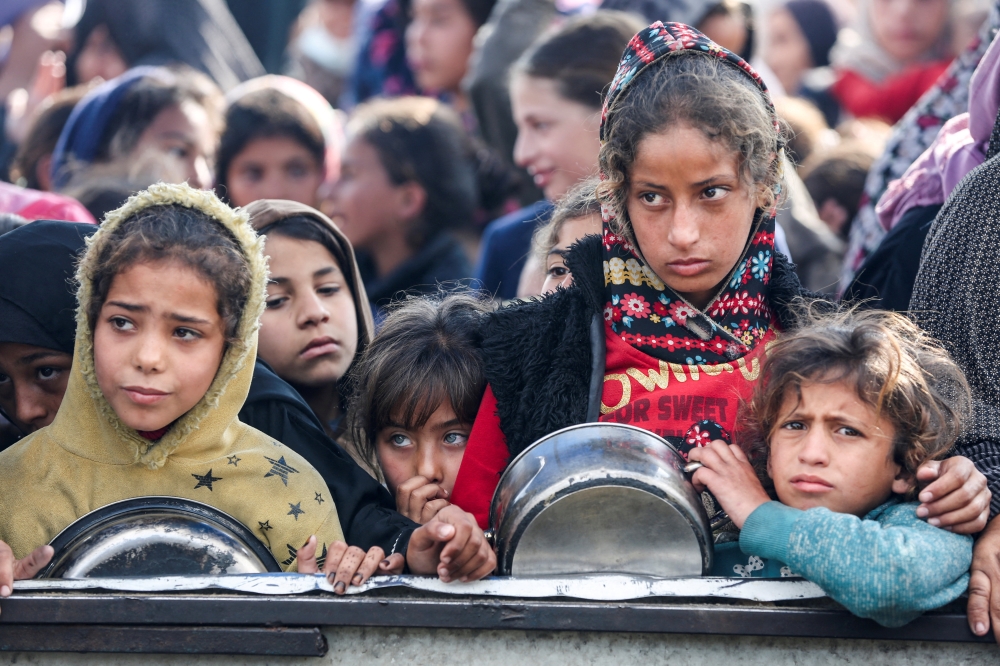 Palestinians gather to receive food cooked by a charity kitchen, in Khan Younis on Friday. Reuters