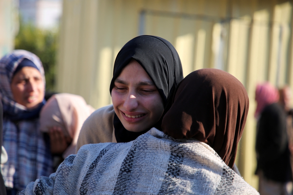 Mourners react, after Palestinians were killed in Israeli airstrikes, before a ceasefire between took effect, in Khan Younis, southern Gaza Strip, on Saturday. - Reuters