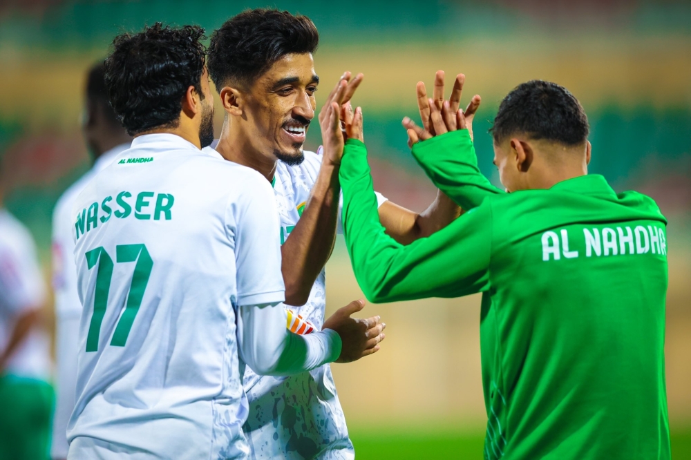 Al Nahda's Ahmed al Kaabi celebrates with teammates after scoring.