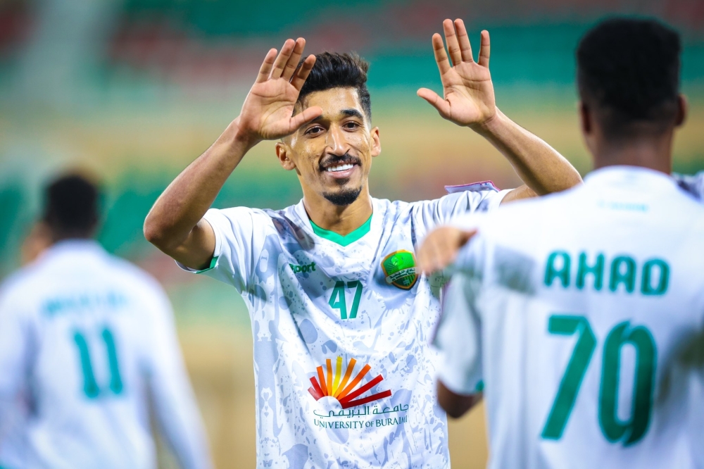 Al Nahda's Ahmed al Kaabi celebrates with teammates after scoring.