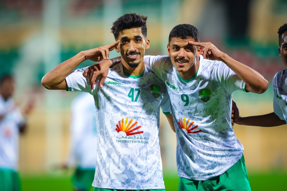 Al Nahda's Ahmed al Kaabi celebrates with teammates after scoring.