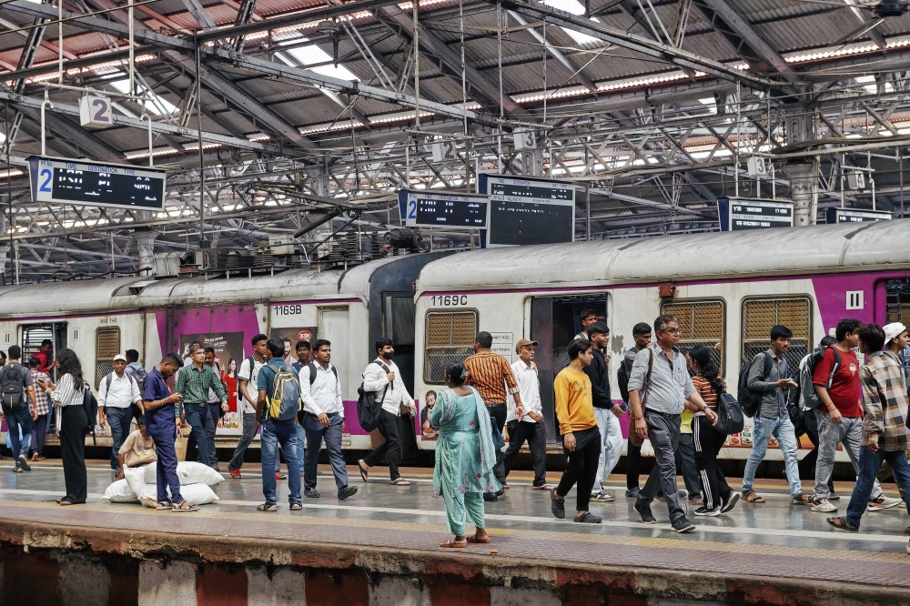 Commuters at a railway station in Mumbai, India, Oct. 8, 2024. (Poras Chaudhary/The New York Times)