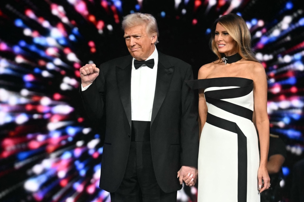 US President Donald Trump (L) and First Lady Melania Trump arrive for the Liberty inaugural ball