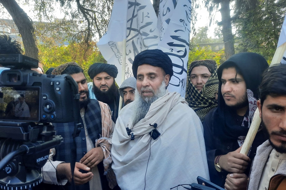 Khan Mohammad (C) speaks to the media as he arrived in Jalalabad. — AFP 