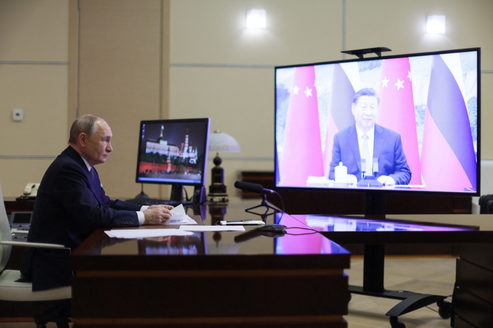 Russia's President Vladimir Putin holds a videocall with Chinese President Xi Jinping at the Novo-Ogaryovo state residence outside Moscow. — AFP 