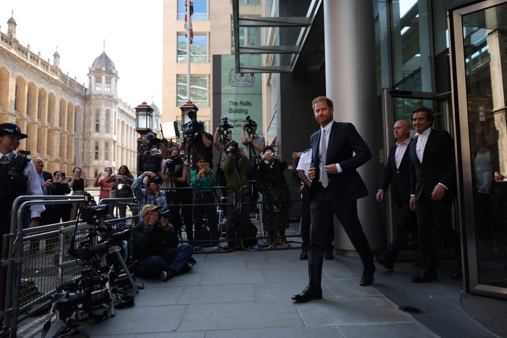 Britain's Prince Harry, Duke of Sussex, walks ahead of his Barrister David Sherborne (R) as he leaves the Royal Courts of Justice, Britain's High Court, in central London. — AFP file photo