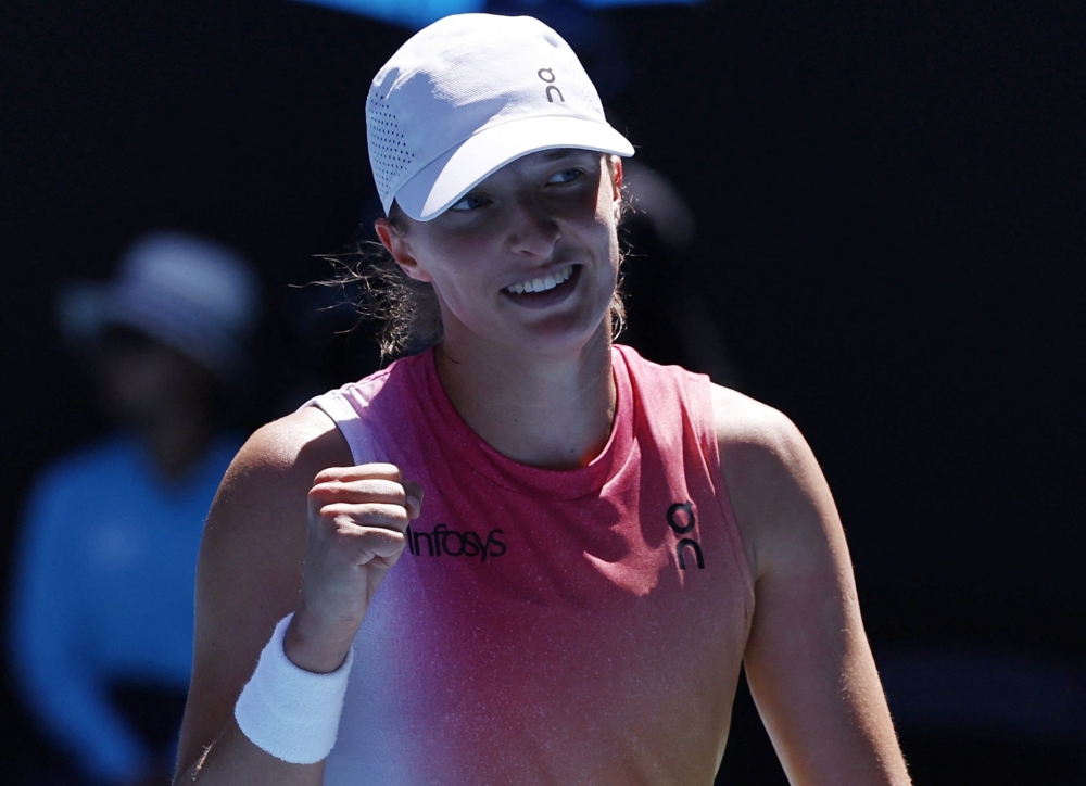 Tennis - Australian Open - Melbourne Park, Melbourne, Australia - January 22, 2025 Poland's Iga Swiatek celebrates winning her quarter final match against Emma Navarro of the U.S. REUTERS/Tingshu Wang
