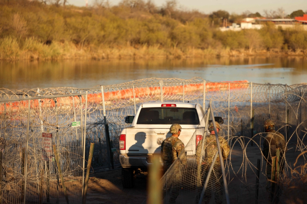 US Army soldiers patrol the US-Mexico border at Eagle Pass, Texas